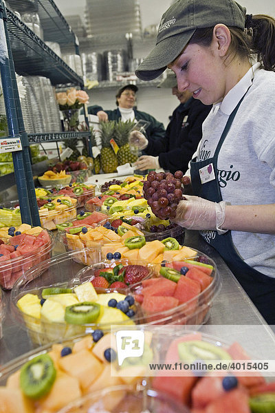 Kelley Parente  19  preparing fruit trays for sale at Nino Salvaggio International Marketplace  Clinton Township  Michigan  USA