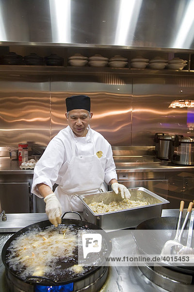 A chef cooking shrimps in a wok at the Palette Dining Studio in the MGM Grand casino  Detroit  Michigan  USA