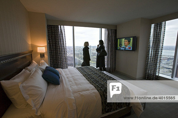 Two women talk in the bedroom of a suite in the hotel at the Greektown Casino  Detroit  Michigan  USA