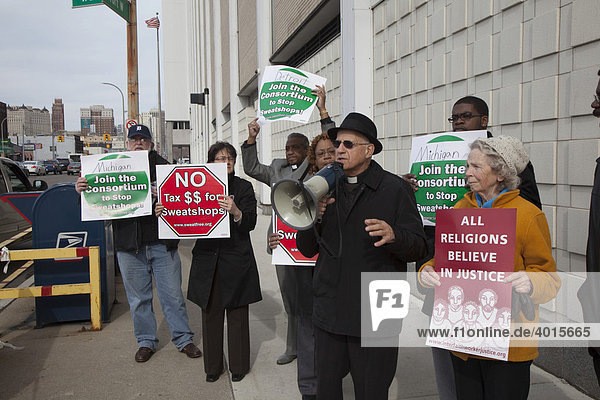 Religious groups rally at the Detroit post office as taxpayers mail their last-minute tax returns to urge that governments stop spending tax dollars to buy uniforms and other items that are made in sweatshops  Detroit  Michigan  USA