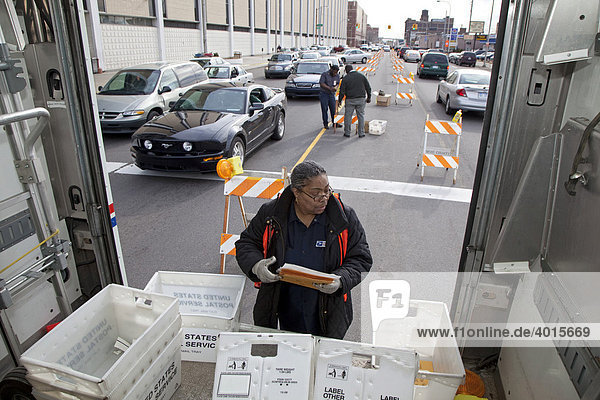 Postal workers collect last-minute tax returns in the street in front of the main post office in the final hours before the income tax filing deadline  Detroit  Michigan  USA