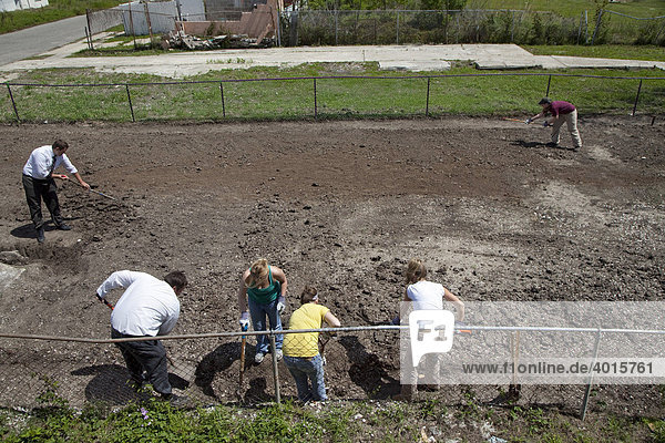 Volunteers  including Mormon missionaries and a group of students from Blue Hens for Christ at the University of Delaware  transform a vacant lot in the lower ninth ward that was flooded by Hurricane Katrina into a community garden  New Orleans  Louisiana  USA