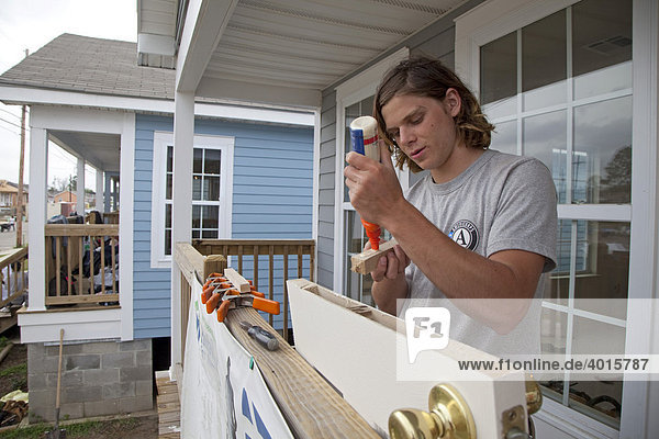An Americorps volunteer works on construction of new homes being built by Habitat for Humanity  New Orleans  Louisiana  USA