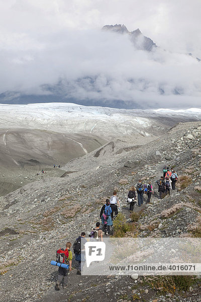 People hike towards Root Glacier in Wrangell-St. Elias National Park  where they will learn ice climbing  Kennicott  Alaska  USA
