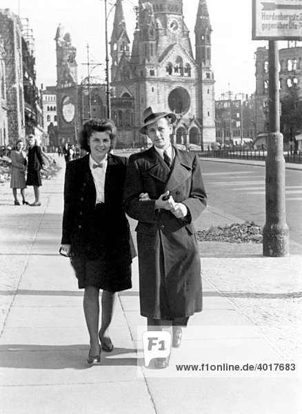 Couple strolling on Tauentzienstrasse  at back the Gedaechtniskirche Church  destroyed to a large extent by Allied bombs in 1943  Berlin  Germany  historic photograph  shortly after the Second World War