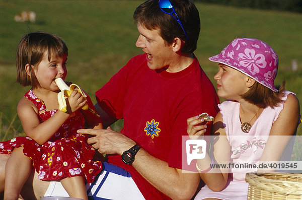 Father picnicing with his daughters on the Ebenforst alpine meadows  Kalkalpen National Park  Upper Austria  Austria  Europe