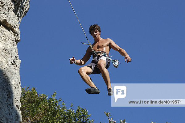Man abseiling while sport climbing  Laussa  Upper Austria  Austria  Europe