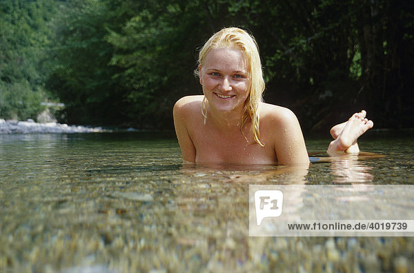 Blond mermaid in a mountain creek in the Reichram Mountains in the Kalkalpen National Park  Austria  Europe