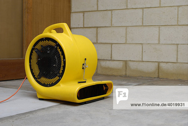 Carpet cleaner's air blower drying a flooded room