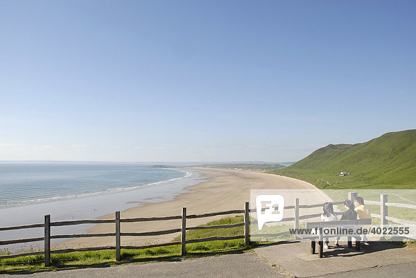 Three youths overlooking the beach and sea at a lookout point  Rhossili Beach  Gower Peninsula  Wales  Great Britain  Europe