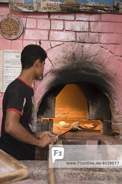 Baker using the oven  bakery  San‘a’  Yemen  Middle East