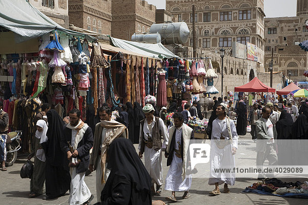 Cloth bazaar  clothes being sold  souk  market  historic centre of San‘a’  Unesco World Heritage Site  Yemen  Middle East
