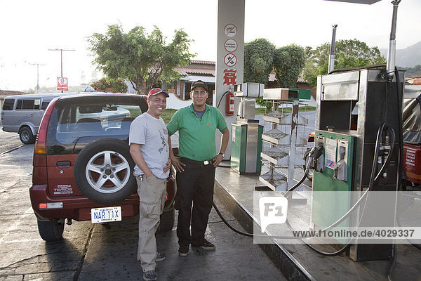 Two men at a petrol station  Mérida  Venezuela  South America