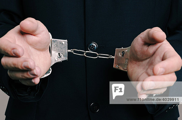 Businessman in handcuffs  partial view