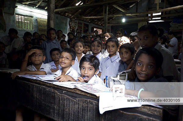 A far too uncommon sight in the slums  a school class  Howrah town  Hooghly  West Bengal  India