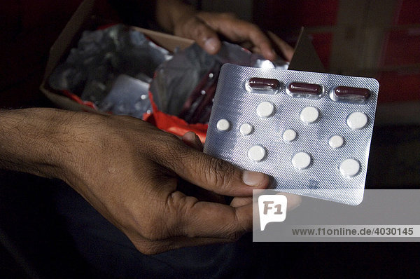 A blister pack with a weeks ration of tuberculosis drugs. Behind a complete therapy carton with the personal half-year ration of one patient. The drugs must be taken under the supervision of a qualified doctor. All empty blister packs are handed in and counted in order to ensure that the treatment is completed. Otherwise dangerous resistance threatens to build up. The drugs are provided free of charge by the state. Howrah  Hooghly  West Bengal  India