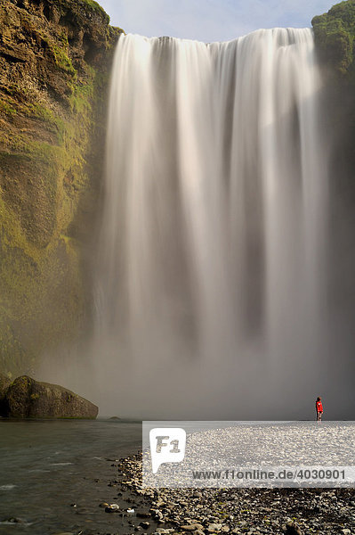 Skógafoss Waterfall with hiker  South Coast  Iceland  Europe