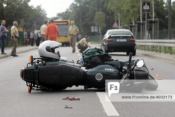 Accident damaged motorbike lying in the road  severe accident involving a motor-cyclist  Pillnitz  Saxony  Germany  Europe