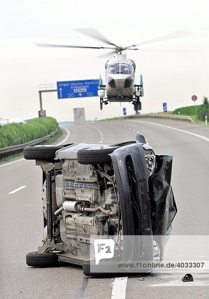 Accident on a motorway car on its side police helicopter landing A 81 to Stuttgart between Zuffenhausen und Ludwigsburg-Sued Stuttgart-Korntal Baden-Wuerttemberg Germany Europe
