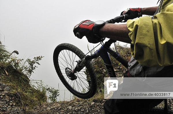 Mountainbiker at the edge of a dangerous cliff  Deathroad  Yungas  La Paz  Bolivia  South America