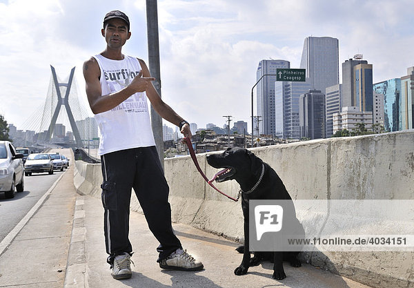 Youngster from the ParaisÛpolis favela with a dog  Morumbi district  Sao Paulo  Brazil  South America