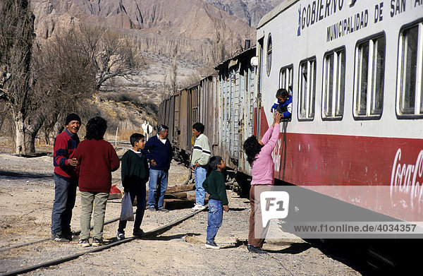 Passengers in front of the carriage of the Train of/to the Clouds  Tren a las nubes  Salta Province  Argentina  South America