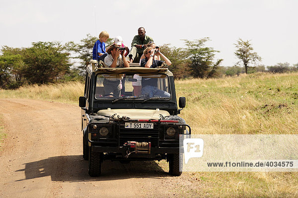 Tourists on a safari  Serengeti National Park  Tanzania  Africa