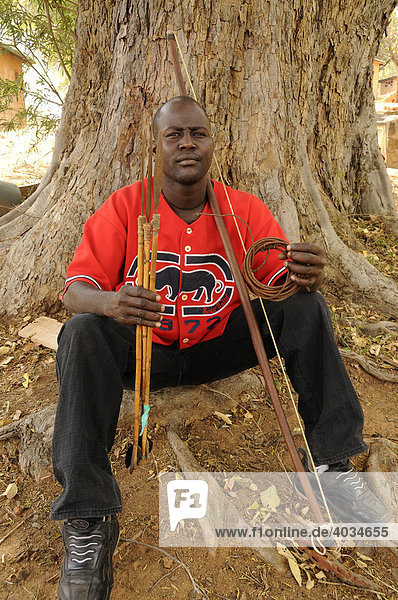 Ranger of the Kenya Wildlife Service  anti-poaching unit  with confiscated arrows  bows and slings in the Park headquarters in Ithumba  Tsavo East National Park  Kenya  Africa