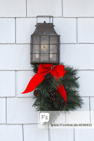 Carriage lantern decorated with pine cone garland and a red bow for Christmas  Oakville  Ontario  Canada