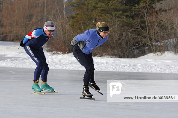 Speed skaters practicing on a frozen pond  Edmonton  Alberta  Canada