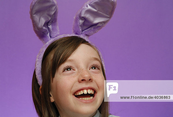 Young girl  age 9  wearing Easter bunny ears