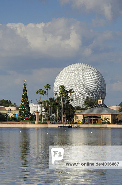 Spaceship Earth and giant Christmas tree as seen across the lake from World Showcase at Epcot  Disney World  Florida  USA