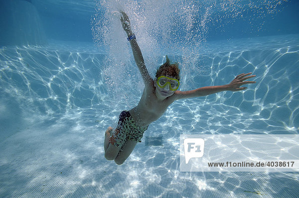 6-year-old boy wearing diving goggles  diving in a swimming pool  underwater picture  Villasimius  Sardinia  Italy  Europe