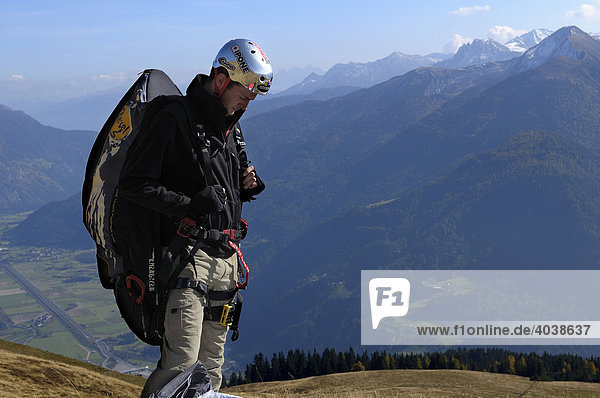 Paraglider mentally preparing for takeoff  Monte Cavallo  Sterzing  Province of Bolzano-Bozen  Italy  Europe