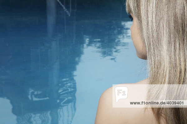 Young dark-blond woman at a swimming pool