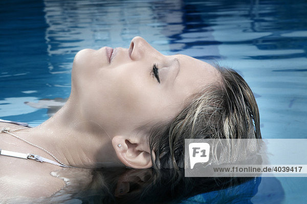 Young dark-blond woman swimming