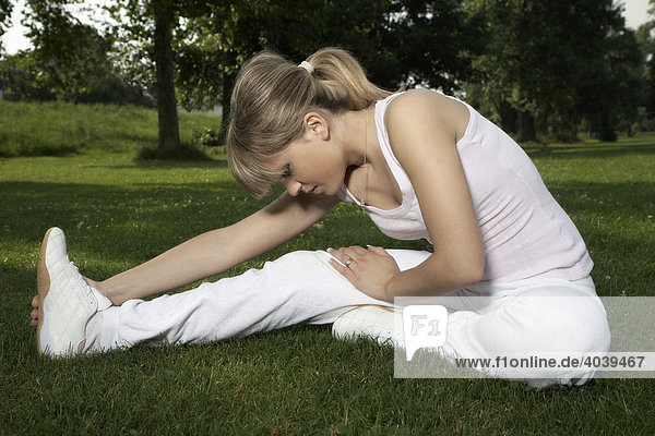 Young dark blonde woman stretching