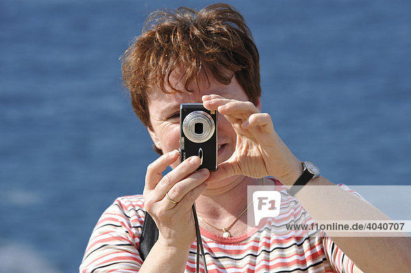Woman taking a picture with a Lumix digital camera