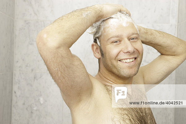 A man with chest hair is having a shower