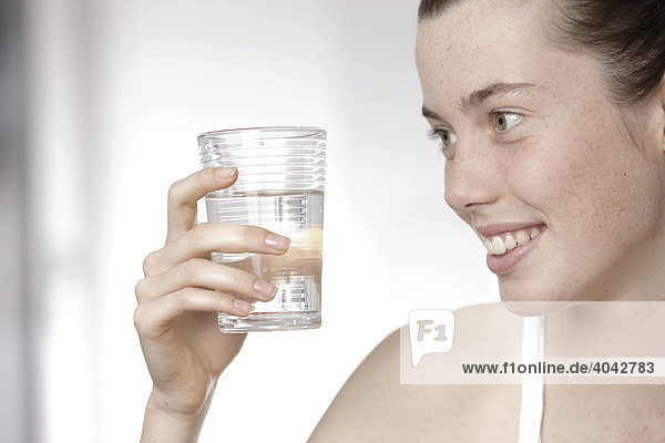 17 year-old girl holding a glass of water