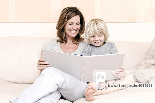 Mother reading a book to her son