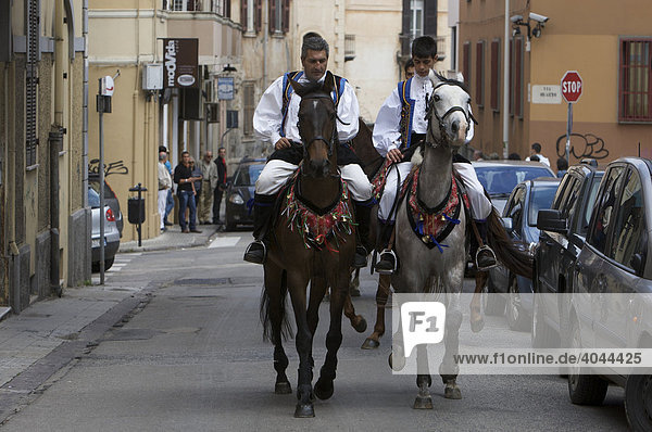 Horseback riders wearing traditional costumes at the Cavalcata Sarda Festival in Sassari  Sardinia  Italy  Europe