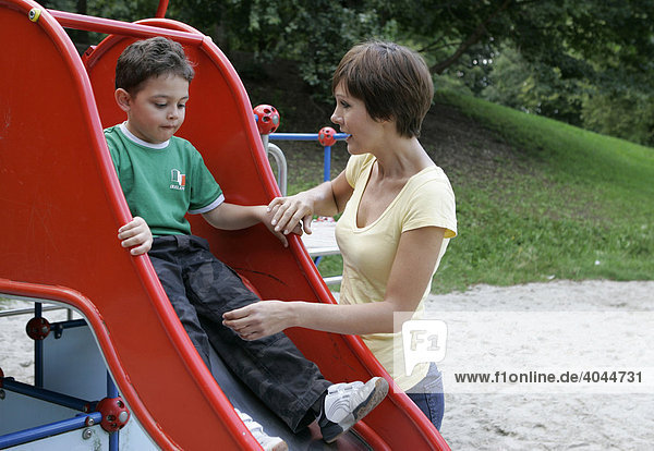 Young mother and son  child in playground
