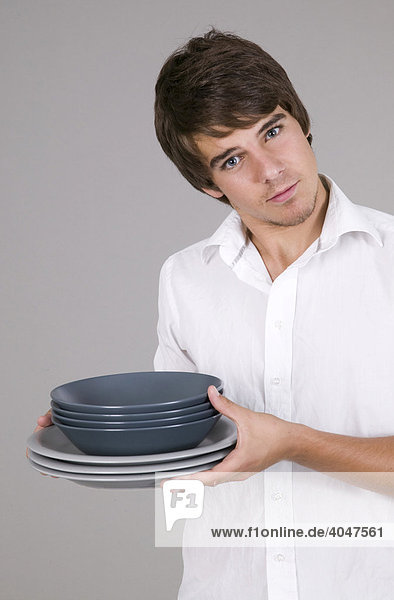 Young man holding crockery