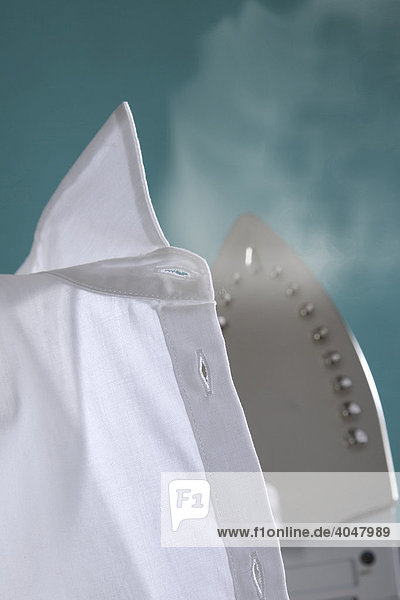 Steaming iron on a white shirt