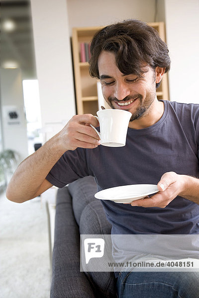 Man cosily drinking a cup of coffee