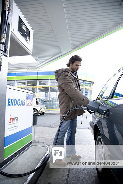 Man filling up his car  petrol station  Bamberg  Bavaria  Germany  Europe