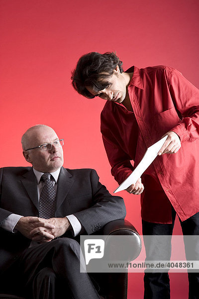 Businessman with an assistant  looking at documents