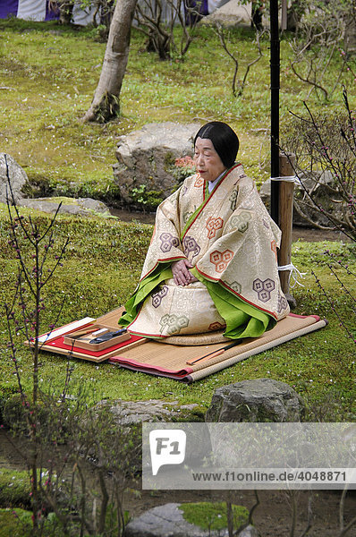 Japanese woman in a kimono of the Heian period sitting at the holy stream in the Kamigamo Shrine  Kyoto  Japan  Asia