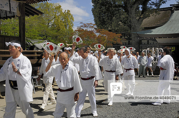 Handles of the shrines being carried accompanied by waving fans  Matsuri Shrine Festival of the Matsuo Taisha Shrine  Shinto  Kyoto  Japan  Asia